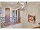 Upper hallway with ornate railing and lovely art at 5960 S Watson Ln, Littleton, CO 80123