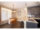 Bright dining area with hardwood floors and chandelier, adjacent to kitchen at 12711 Colorado Blvd # 912, Thornton, CO 80241