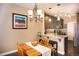 Bright dining area with hardwood floors and chandelier, adjacent to kitchen at 12711 Colorado Blvd # 912, Thornton, CO 80241