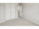 A cozy bedroom featuring light gray walls, plush carpeting, and closet with sliding doors at 2175 Alyssa St, Fort Lupton, CO 80621