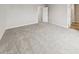 A light gray bedroom featuring plush carpeting and a white entry door at 2175 Alyssa St, Fort Lupton, CO 80621