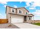 Charming two-story home showcasing a two-car garage, light brown siding, and an expansive driveway at 2175 Alyssa St, Fort Lupton, CO 80621