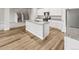 A spacious kitchen featuring stainless steel appliances, granite countertops, and light-colored wood flooring at 2175 Alyssa St, Fort Lupton, CO 80621