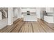 A spacious kitchen with granite countertops, stainless steel appliances, an island, and light-colored wood flooring at 2175 Alyssa St, Fort Lupton, CO 80621