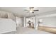 Open concept living space with kitchen view, featuring gray carpeted floors and ample natural light at 2175 Alyssa St, Fort Lupton, CO 80621