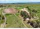 Aerial view highlighting the property's expansive green pastures, trees, and horse training facilities at 2470 Driftwood, Elizabeth, CO 80107