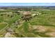 Sweeping aerial view displays the property's sprawling green land, wooded areas, and horse training complex at 2470 Driftwood, Elizabeth, CO 80107