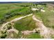 Expansive aerial view showcases a landscape with sandy creek beds, green fields, and scattered trees at 2470 Driftwood, Elizabeth, CO 80107