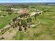 Gorgeous aerial shot showcases the property, beautiful grounds, mature trees, and horse training facilities at 2470 Driftwood, Elizabeth, CO 80107