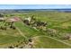 Panoramic aerial shot outlines the property with sprawling greenery, mature trees, and riding facilities at 2470 Driftwood, Elizabeth, CO 80107