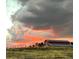Picturesque barn with a vibrant sunset backdrop, creating a stunning and peaceful scene at 2470 Driftwood, Elizabeth, CO 80107