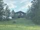Charming home exterior with a rustic design nestled among tall trees in a serene location at 2470 Driftwood, Elizabeth, CO 80107