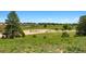 Picturesque landscape with lush greenery and mature trees, showcasing a tranquil and inviting property at 2470 Driftwood, Elizabeth, CO 80107