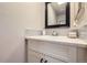 Bright bathroom with a modern vanity, stylish mirror, and decorative backsplash at 15976 E Radcliff Pl # A, Aurora, CO 80015