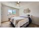 Bright bedroom featuring a comfortable bed, natural light, and a ceiling fan at 15976 E Radcliff Pl # A, Aurora, CO 80015