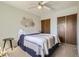 Well-lit bedroom featuring a comfortable bed, a ceiling fan, and natural light at 15976 E Radcliff Pl # A, Aurora, CO 80015