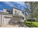 Inviting two-story home with attached garage, showcasing a tidy lawn and mature shade tree at 15976 E Radcliff Pl # A, Aurora, CO 80015