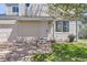 Welcoming home entrance with a small lawn and planted pot, plus an attached one-car garage at 15976 E Radcliff Pl # A, Aurora, CO 80015