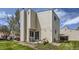 Back exterior view showing siding and a patio with seating in a grassy yard at 15976 E Radcliff Pl # A, Aurora, CO 80015