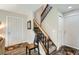 The home's entry foyer features hardwood floors and a staircase with wood banister and carpeted steps at 15976 E Radcliff Pl # A, Aurora, CO 80015