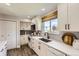 Bright kitchen with quartz countertops, white cabinetry, and stainless steel appliances at 15976 E Radcliff Pl # A, Aurora, CO 80015