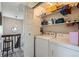 Convenient laundry area with a washer, dryer, and shelving for storage at 15976 E Radcliff Pl # A, Aurora, CO 80015