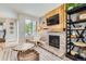 Cozy living room featuring a decorative fireplace and entertainment area, with decor and natural light at 15976 E Radcliff Pl # A, Aurora, CO 80015