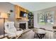 Relaxing living room with a stone fireplace, wood accent wall, and stylish decor for comfortable living at 15976 E Radcliff Pl # A, Aurora, CO 80015