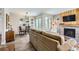 A living room showcasing a fireplace, a view into the dining area, and lots of natural light at 15976 E Radcliff Pl # A, Aurora, CO 80015