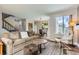 Bright and open living room area, adjacent to the staircase and eat-in kitchen, with large windows at 15976 E Radcliff Pl # A, Aurora, CO 80015