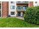 Backyard view of condo with patio, balcony and green space at 401 S Kalispell Way # 104, Aurora, CO 80017