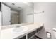 Bright bathroom with vanity, sink, large mirror, and shower with glass door, well-maintained and functional at 401 S Kalispell Way # 104, Aurora, CO 80017