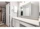Bright bathroom featuring a white vanity with a sink and a shower with a patterned shower curtain at 401 S Kalispell Way # 104, Aurora, CO 80017