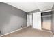 Neutral bedroom with carpet, gray walls, and a closet, offering a serene and comfortable space at 401 S Kalispell Way # 104, Aurora, CO 80017