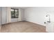 Neutral bedroom with a large window providing natural light and tan carpet at 401 S Kalispell Way # 104, Aurora, CO 80017