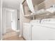 Laundry area with washer, dryer, and shelving, offering convenient in-unit laundry solutions at 401 S Kalispell Way # 104, Aurora, CO 80017