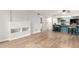 Open-concept living room flows into the kitchen and features updated flooring at 401 S Kalispell Way # 104, Aurora, CO 80017