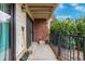 Outdoor patio with black metal railing, brick accents, and a sliding door, ideal for relaxation at 401 S Kalispell Way # 104, Aurora, CO 80017
