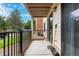 Outdoor patio with black metal railing, brick accents, and a sliding door, ideal for relaxation at 401 S Kalispell Way # 104, Aurora, CO 80017