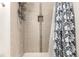 Nicely tiled shower with a multi-setting shower head and a built in shampoo niche at 401 S Kalispell Way # 104, Aurora, CO 80017