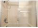 Enclosed shower with tile surround, hand-held wand, and glass sliding door, providing a clean bathing space at 401 S Kalispell Way # 104, Aurora, CO 80017