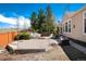 Lush backyard featuring a hot tub, rock landscaping, and a wooden privacy fence at 11302 Mesa Verde Pl, Parker, CO 80138