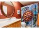 Colorful bathroom with turtle shower curtain, round mirror, and clean white sink at 11302 Mesa Verde Pl, Parker, CO 80138