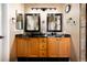 Updated bathroom with double sinks, granite countertops, and modern lighting fixtures at 11302 Mesa Verde Pl, Parker, CO 80138