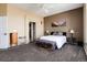 Cozy bedroom showcasing a comfortable bed, soft lighting, and mountain artwork at 11302 Mesa Verde Pl, Parker, CO 80138