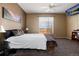 Spacious bedroom boasts plush carpet, a window with blinds, and a mounted TV at 11302 Mesa Verde Pl, Parker, CO 80138