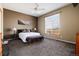Bright bedroom featuring neutral paint, ceiling fan, and large window with natural light at 11302 Mesa Verde Pl, Parker, CO 80138