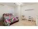 Cozy bedroom featuring a bright floral comforter, a ceiling fan, and a traditional wicker chair at 11302 Mesa Verde Pl, Parker, CO 80138