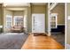 Inviting foyer featuring hardwood floors, a bright front door with sidelights, and a view into the carpeted living room at 11302 Mesa Verde Pl, Parker, CO 80138