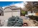 Attractive home exterior featuring a two-car garage, stone facade, and neatly arranged landscaping elements at 11302 Mesa Verde Pl, Parker, CO 80138